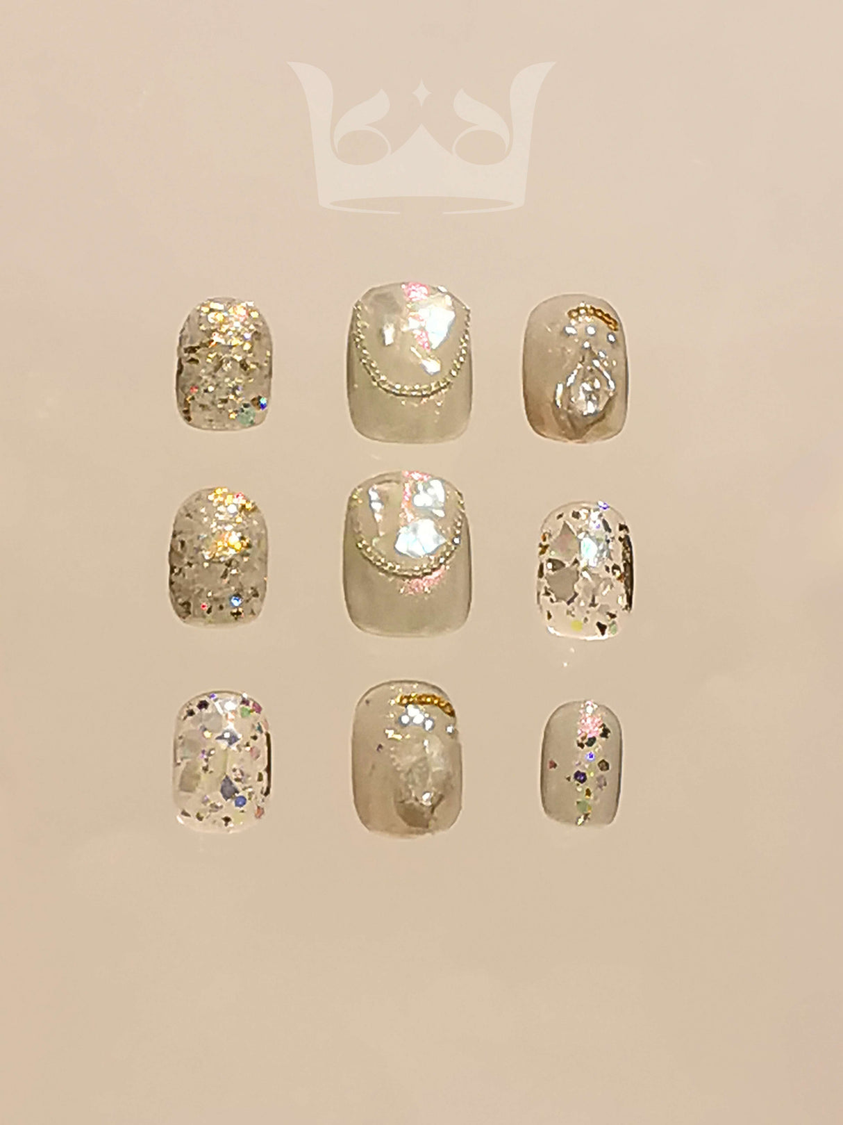 These press-on nails have a sparkly and glamorous design featuring large glitter flakes, rhinestones, sequins, and accent designs. The clear or nude base color adds elegance and extra sparkle.