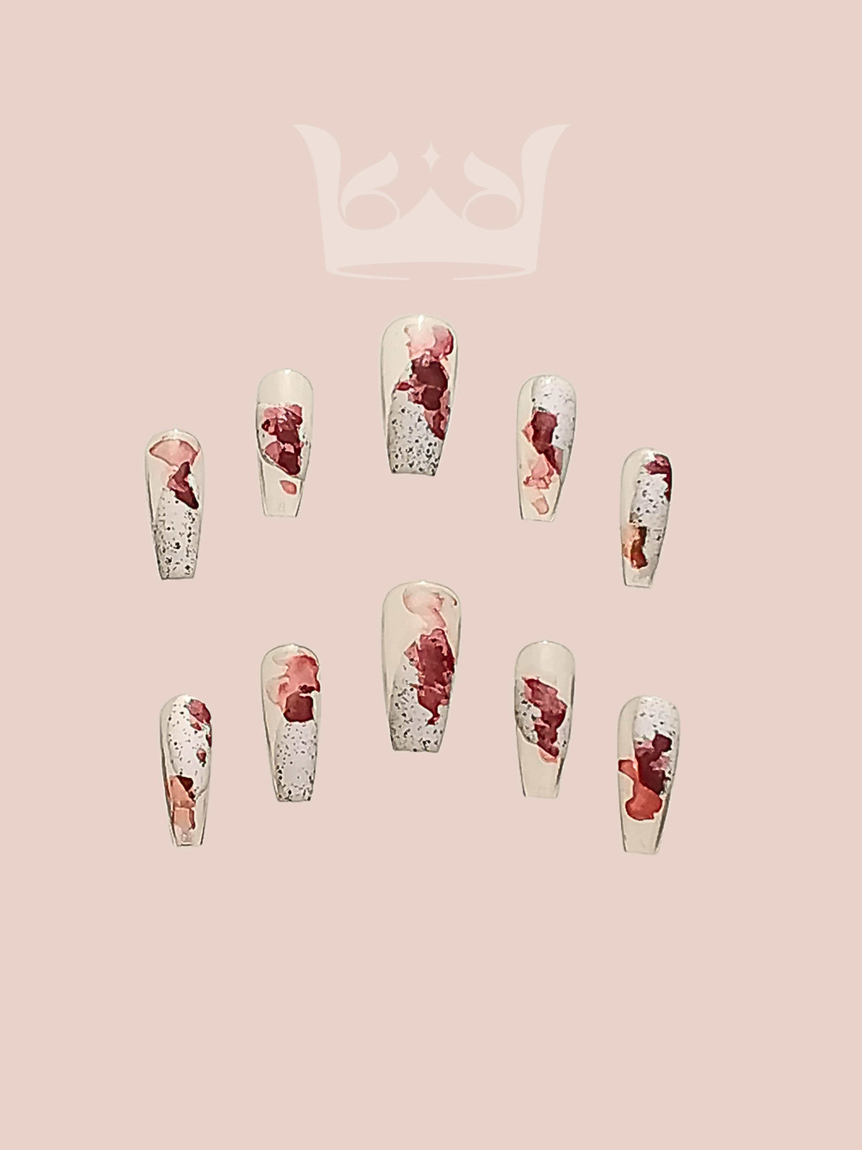 These press-on nails feature abstract or marble-like patterns, predominantly in shades of red and white, with some gold accents. The nails are long and have a coffin or ballerina shape