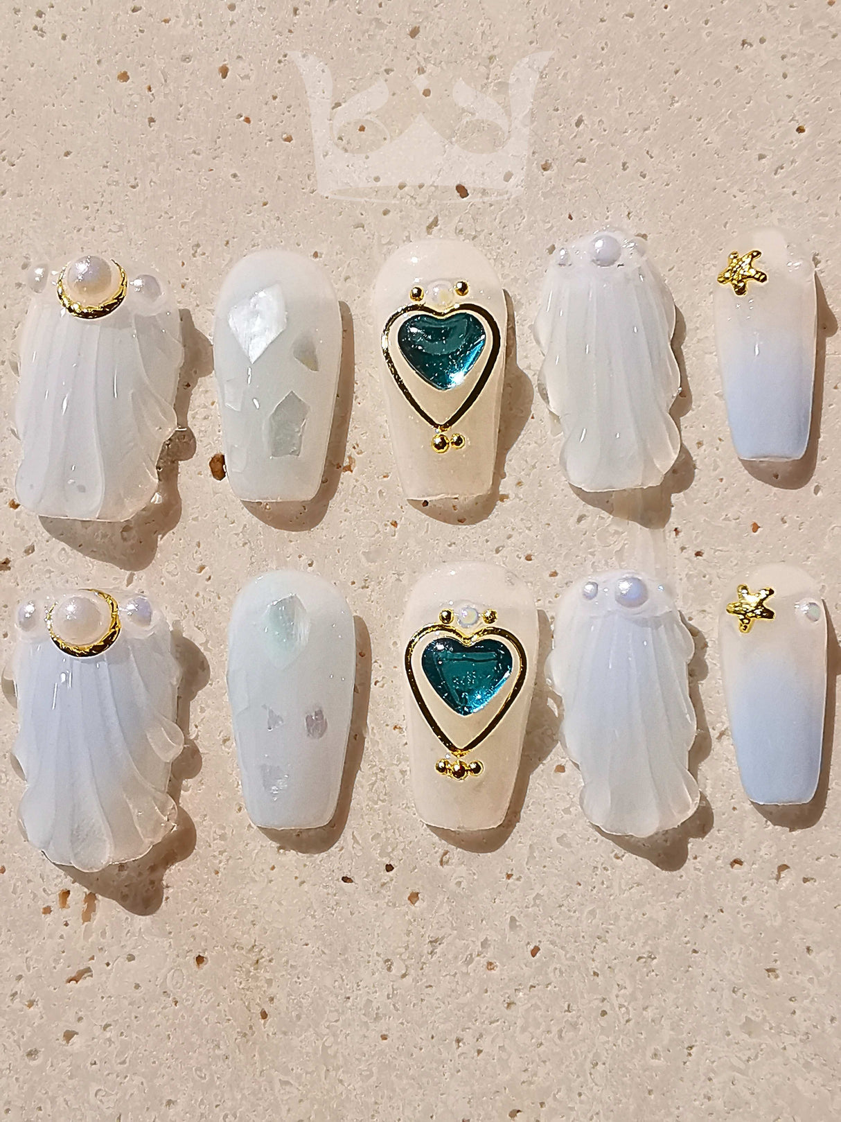 Luxury nail tips made of acrylic with white, semi-translucent appearance and cute elements like pearls, hearts, and stars. Ideal for special occasions.