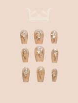 Luxurious and cute golden, metallic nails with small embellishments or crystals in varying sizes for natural nails. 