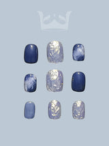 Navy blue short press on nails with round nail tip. Featuring chrome, metallic color, marble painting, and squoval nail shape. Luxury nail art design for summer nails.
