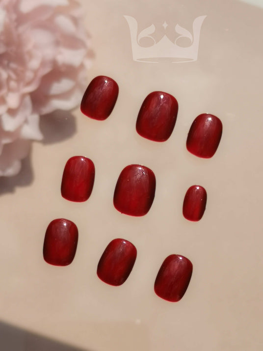 These press-on nails are for manicures, with a glossy finish and deep red color for a polished appearance. They may be part of a larger nail care kit.