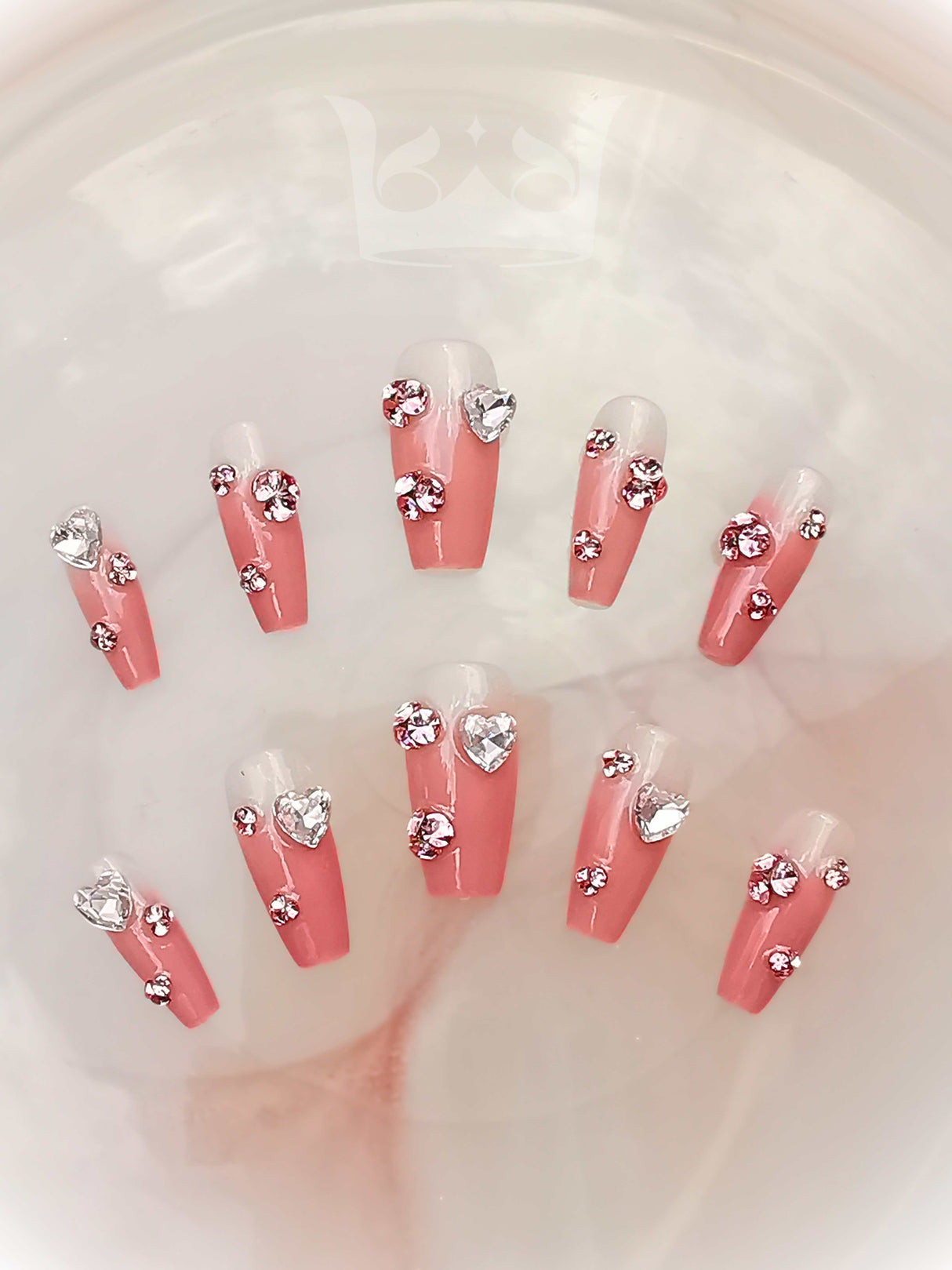 These press-on nails are designed for special occasions or as a statement accessory. They are pre-designed and vary in length, with a non-uniform arrangement of stones for a unique look.