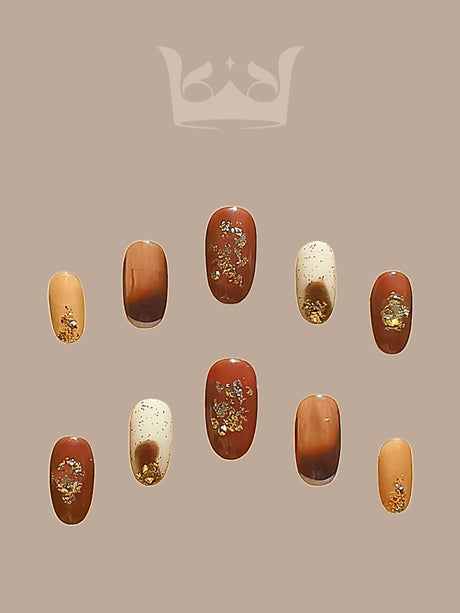Fashionable nails with earthy tones, artistic embellishments, and a glossy finish for stylish wear and coordinated looks. Ideal for making a fashion statement.