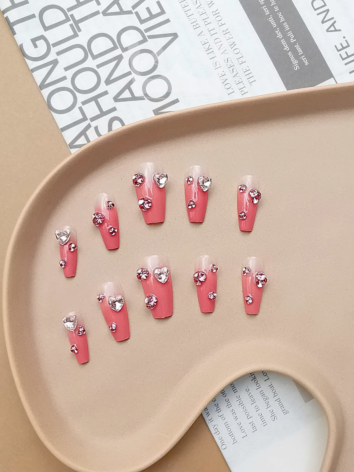 These press-on nails are for a special occasion, with large rhinestone embellishments adding a glamorous effect. Short to medium length and rounded shape for practicality.