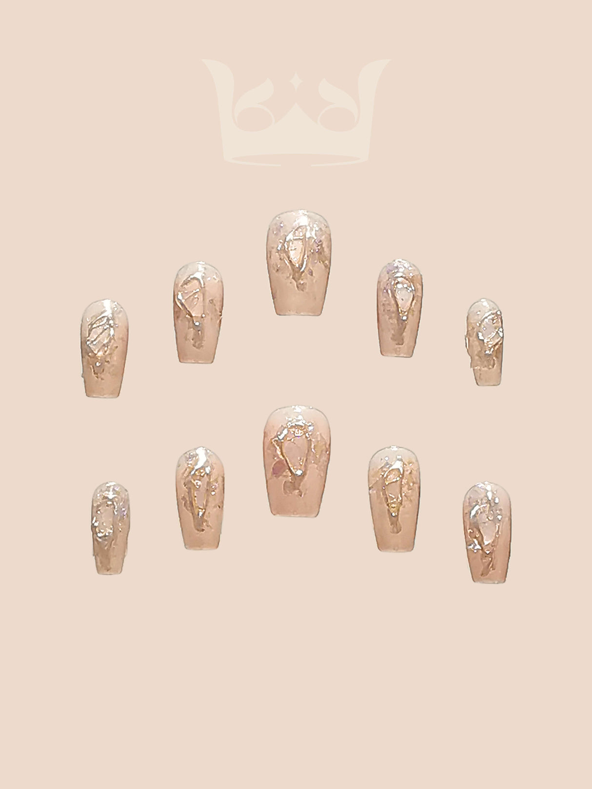 These false nails have a nude base with metallic gold accents in abstract patterns and are designed for a stylish and fancy look.