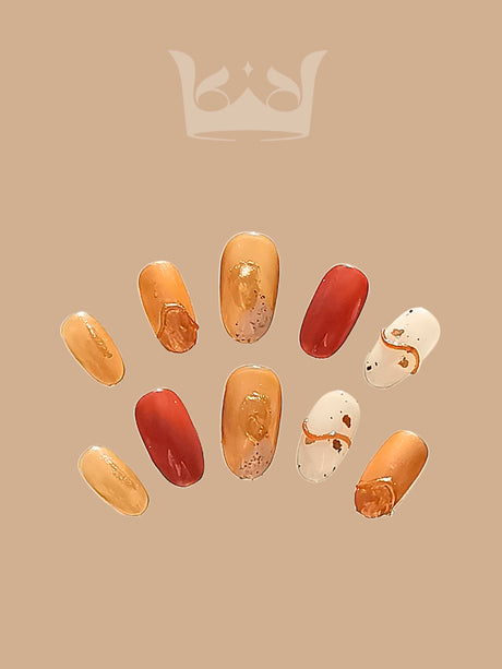 Luxury nails with warm tones of gold and deep red, featuring metallic finish and abstract pattern with golden flakes, for an elegant and luxurious look.