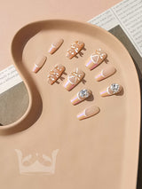 Cute nails with various designs and techniques used in nail art for self-expression and personal style. Neutral and earthy color palette with gold accents achieved through various techniques.