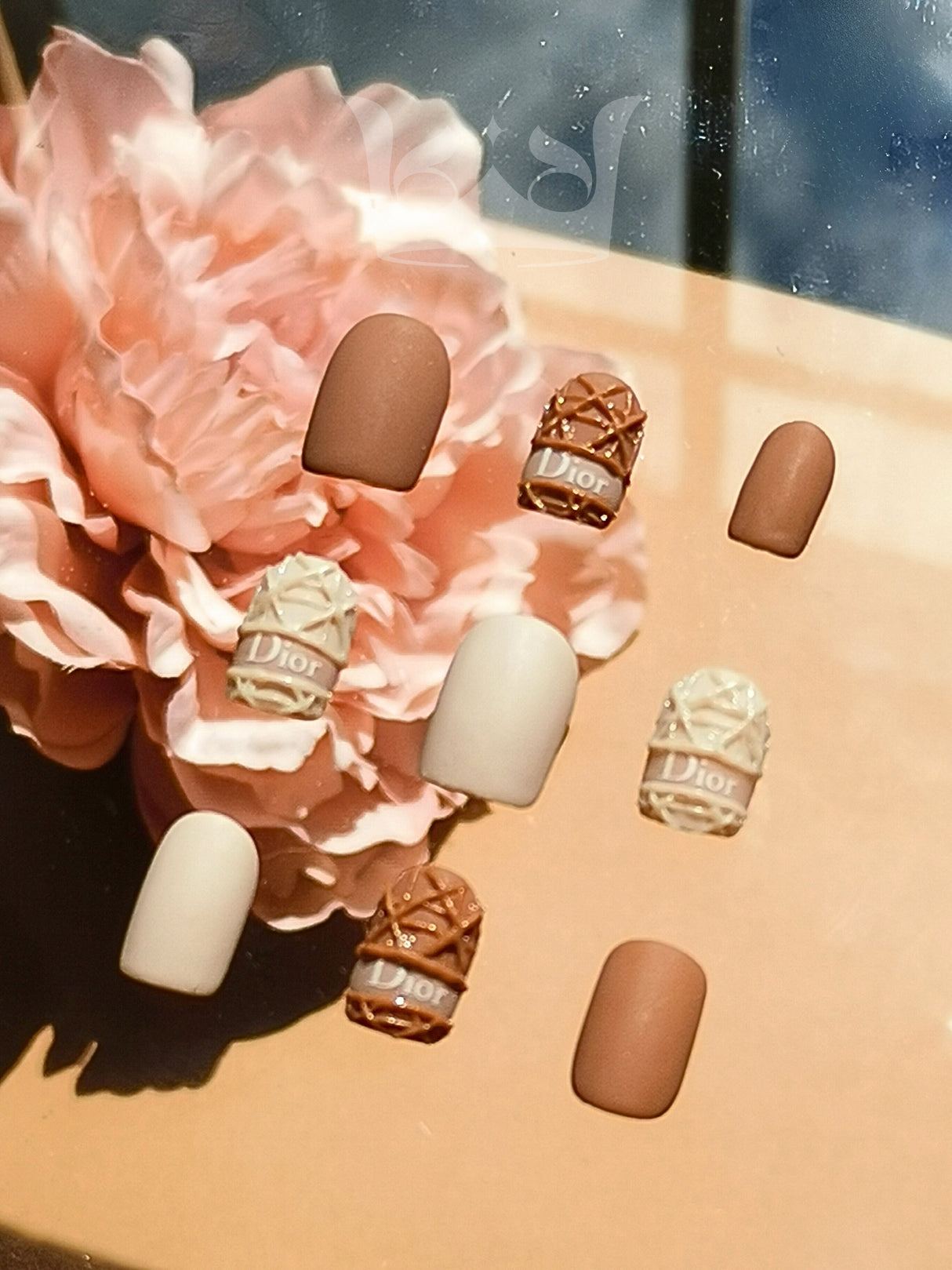 Dior nails are a luxurious fashion accessory suitable for special occasions, with branded embellishments and design elements for a fancy look.