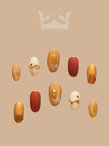 Luxurious and festive nails with warm tones and unique design elements are perfect for special occasions or events, making a statement for the wearer.