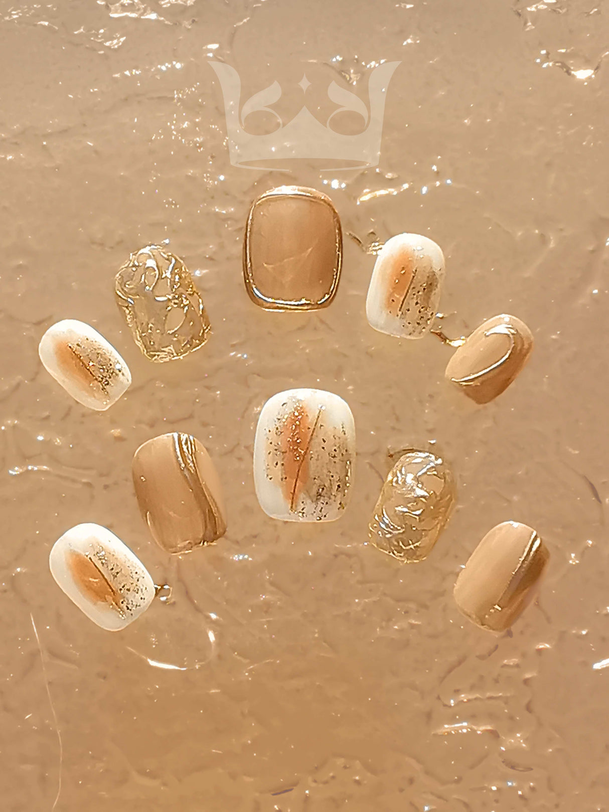 These press-on nails offer a stylish and fancy look with modern designs including a neutral color palette, marble effect, glitter accents, and metallic stripe.