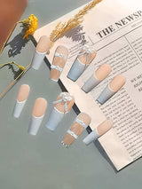 These press-on nails are ideal for special occasions, featuring a pastel blue color, French tips, negative space, and delicate bows for a feminine and elegant look.