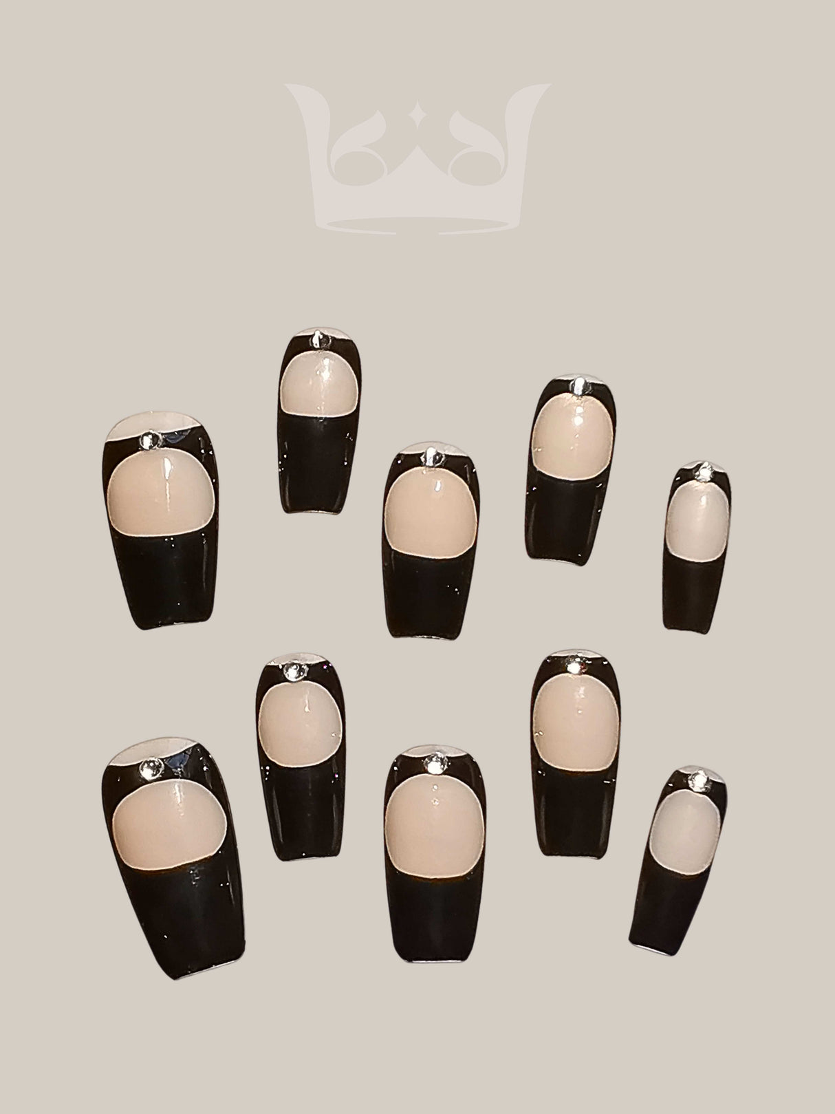 Stylish nails with a two-tone design, nude base color, black tip, and silver stud. Available in coffin or ballerina style for a modern and edgy look.