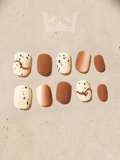 These press-on nails are for personal fashion and self-expression, with an earthy color palette and playful designs. Varying sizes and a rounded tip give a natural look.