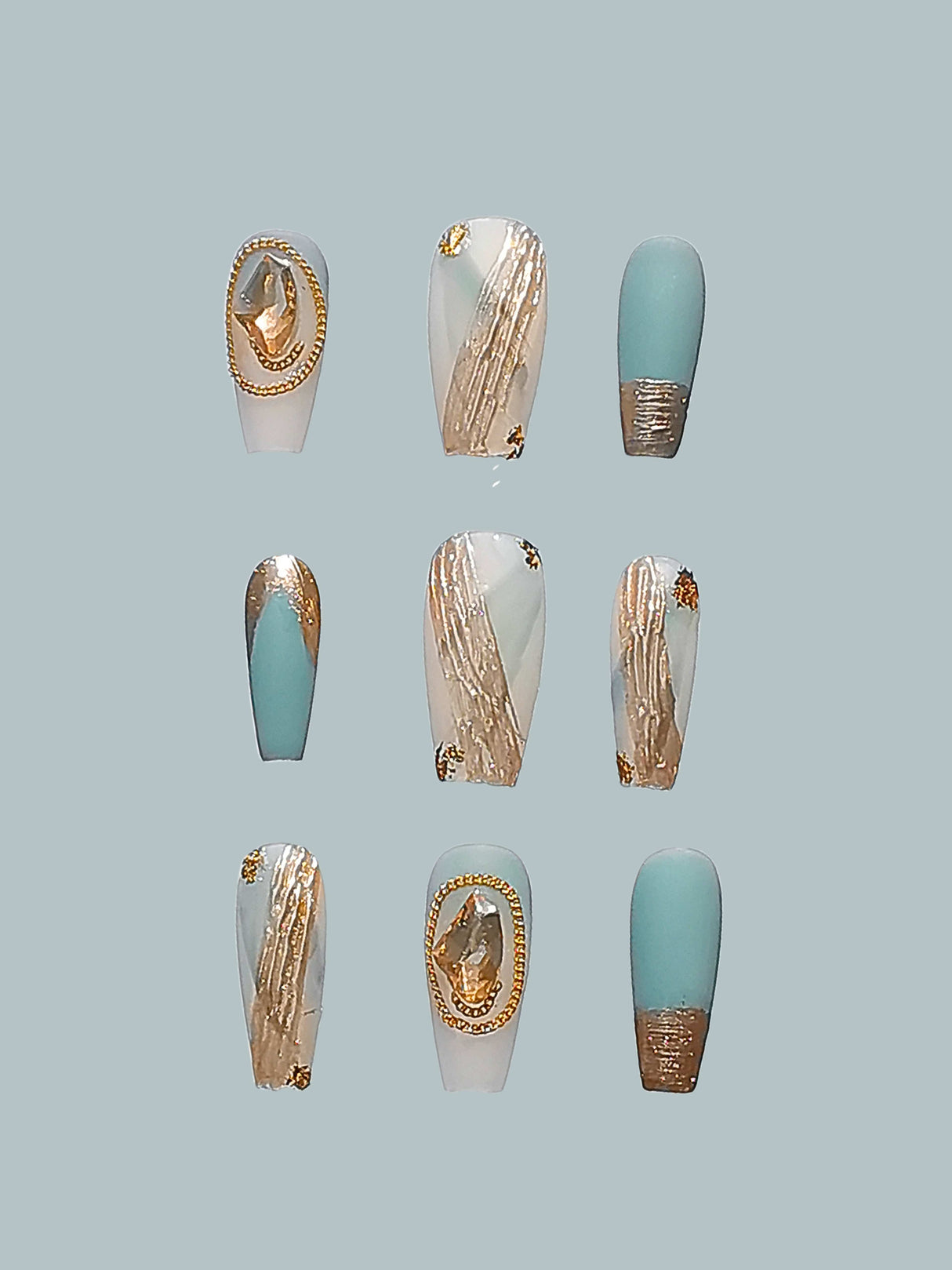 Elegant and trendy nails with pastel blue, white, and gold accents, perfect for special occasions or fashion statements. Bold canvas for nail art.