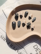 Luxurious and dramatic nails with matte and glossy black finishes, gemstone-like embellishments, and textured designs for special occasions or fashion-forward events.